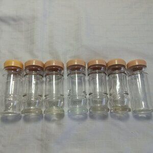 Seven empty glass spice jars